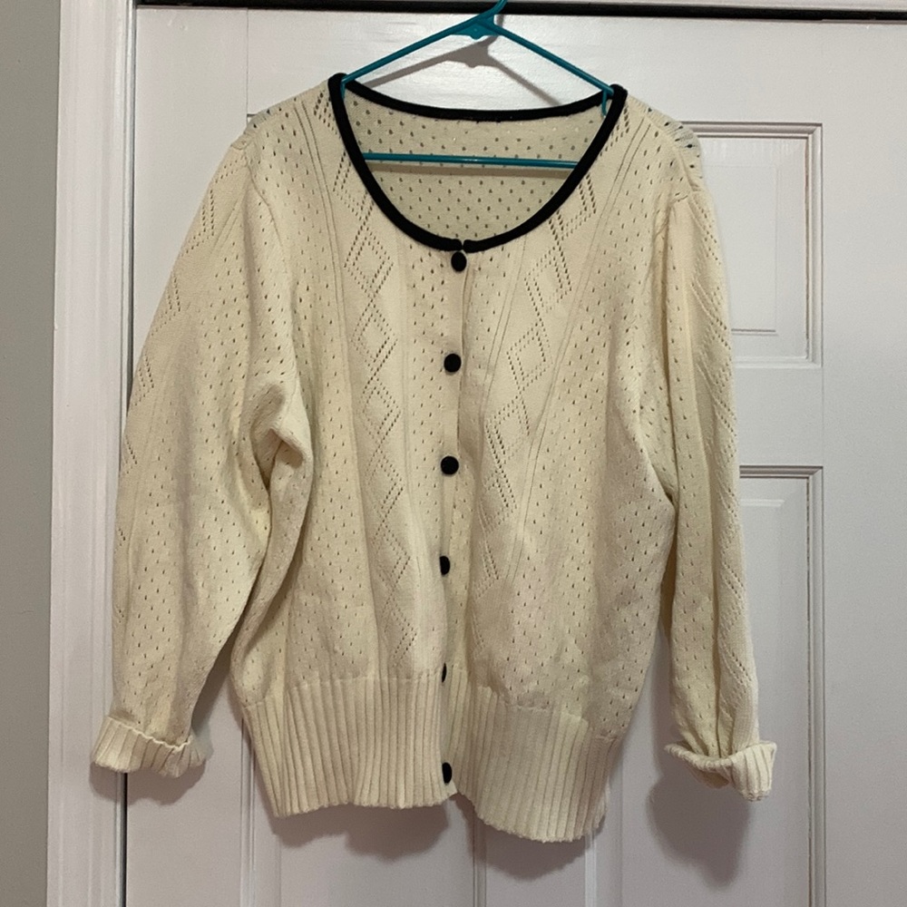 Women’s cream sweater with black trim neckline